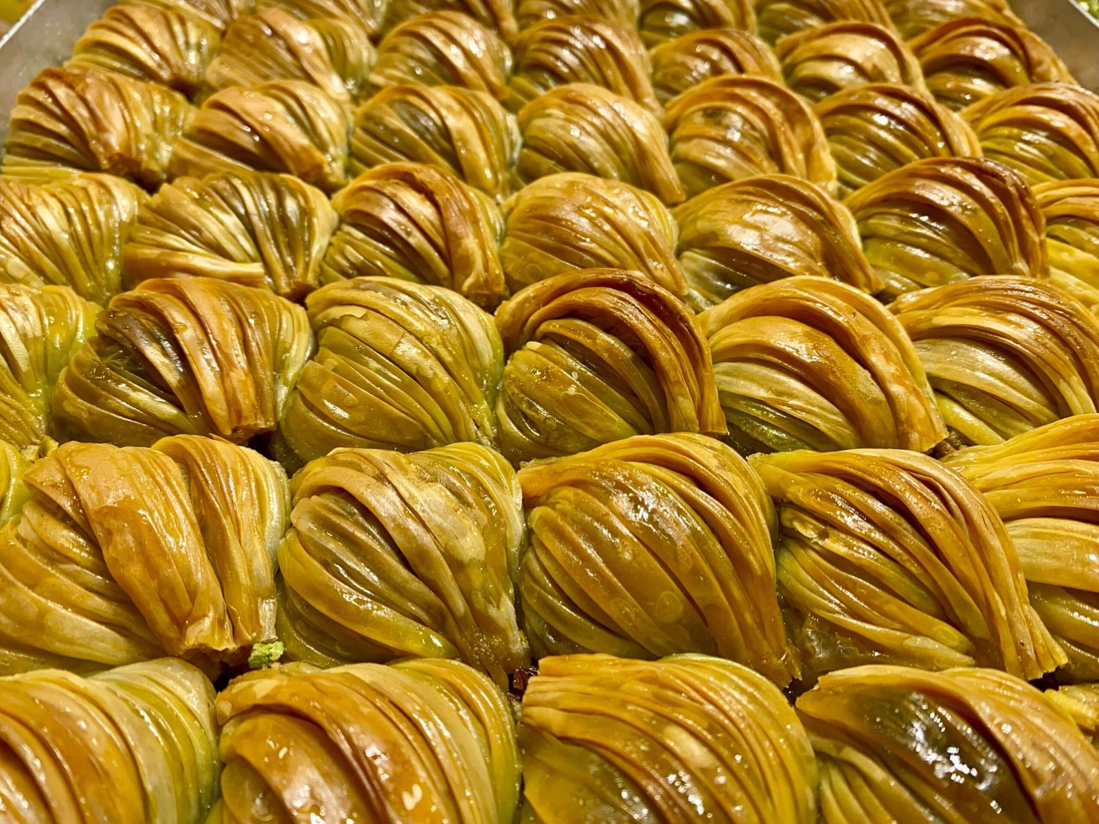 Delicious and traditional Midye Baklava from Türkiye, showcasing golden phyllo layers and rich pistachio filling.